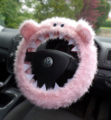 Baby Pink fuzzy monster steering wheel cover with ears, felt teeth and googly eyes on a Volkswagen Steering wheel - handmade by Poppys Crafts