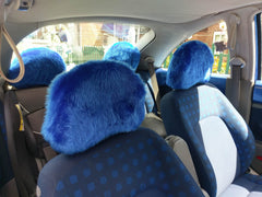 Four Royal Blue fluffy faux fur car headrest covers fitted on car seats 